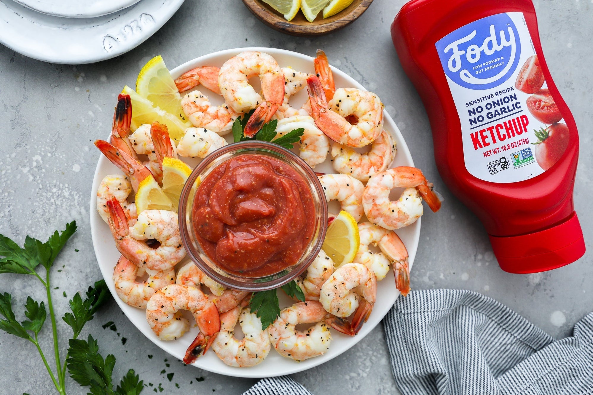 Shrimp arranged on a plate with Fody's homemade cocktail sauce