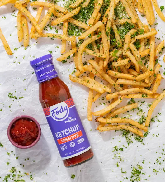 Fody Original Ketchup bottle beside crispy french fries sprinkled with parsley on white paper