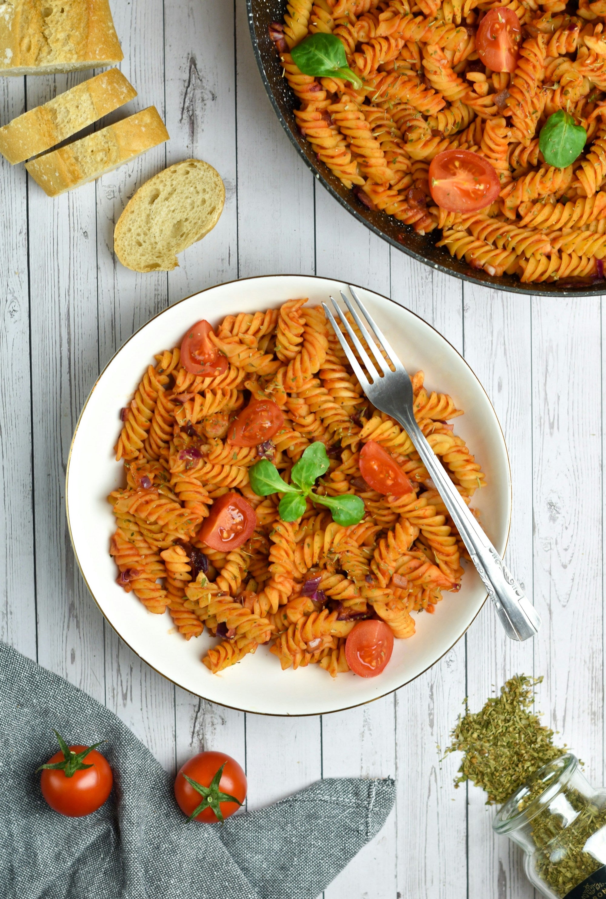 Pasta with tomato sauce on a white plate — a Low FODMAP dinner option for managing IBS and GERD together&nbsp;
