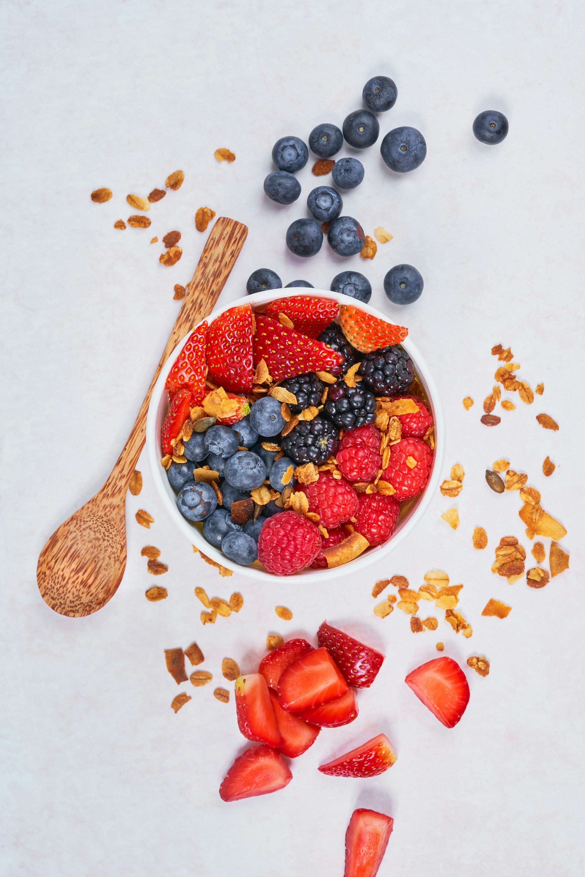 Fresh strawberries and blueberries in a white bowl — Low FODMAP fruits for GERD and IBS management&nbsp;
