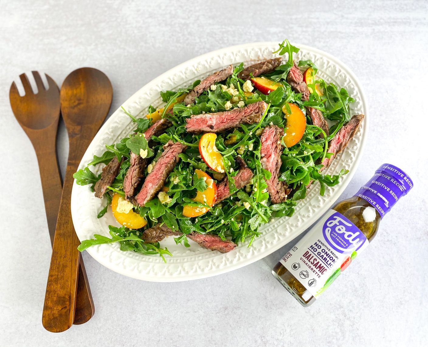 Fody low fodmap salad with steak, peaches, arugula, and blue cheese